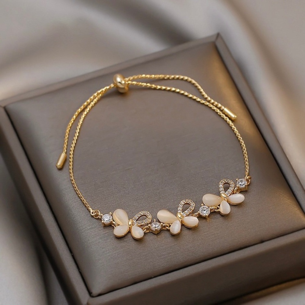 Gold Tone Floral Bracelet with Cream Petal Accents